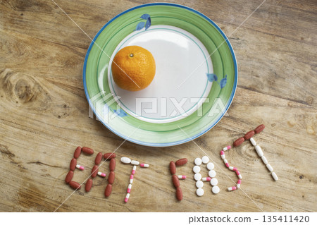 eat fast message with pills and half plate of food on table eat fast message with pills and half plate of food on table 135411420