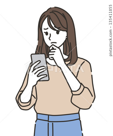 A young woman worried while looking at her smartphone A young woman worried while looking at her smartphone 135411855