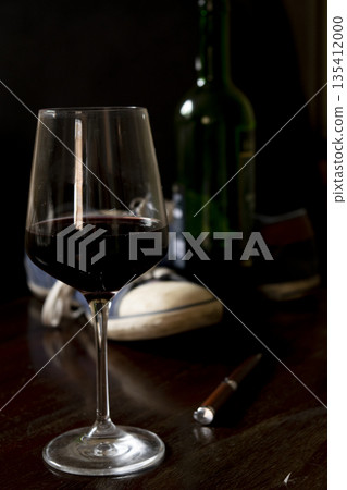 glass of red wine in dim light glass of red wine in dim light 135412000