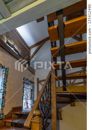 Unique rustic staircase with branch-style metal railings and mosaic 135412490