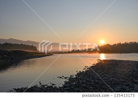 The morning sun rises over the river 135413173