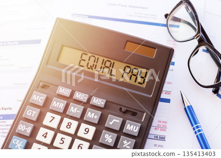 Calculator Displaying Equal Pay on Financial Documents 135413403