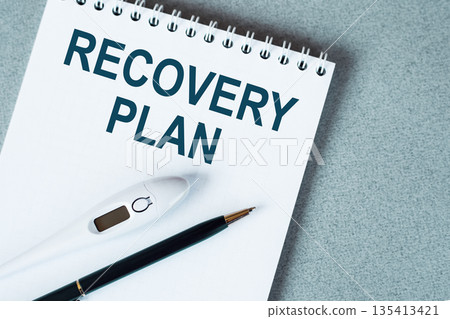 Blank notebook with thermometre and pen on table. RECOVERY PLAN text. Blank notebook with thermometre and pen on table. RECOVERY PLAN text. 135413421