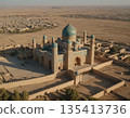 Aerial view of a historic mosque surrounded by desert landscapes under a clear sky at sunset. Generative AI 135413736