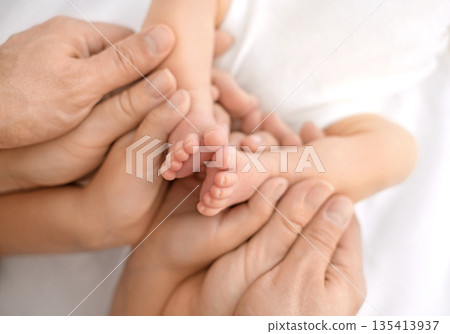 Tiny pink fingers of a newborn in the hands of his father, mother and sister. 135413937