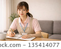 A woman working as a caregiver takes notes in a notebook 135414077