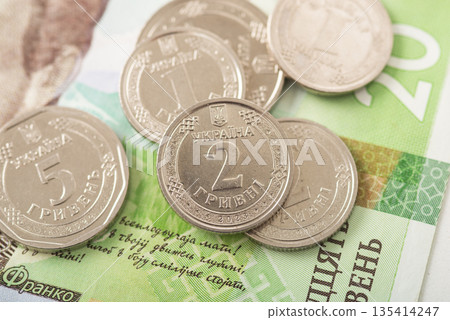 Close-up of Ukrainian hryvnia coins on banknotes, representing national currency, finance, economy, cash transactions Close-up of Ukrainian hryvnia coins on banknotes, representing national currency, finance, economy, cash transactions 135414247