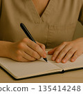 A woman working as a caregiver takes notes in a notebook 135414248