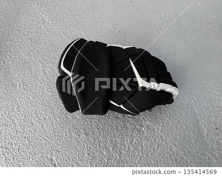 hockey glove on the gray background hockey glove on the gray background 135414569