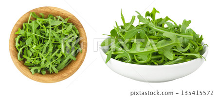 Heap of green fresh rucola or arugula leaf in wooden and ceramic bowl isolated on white background. Top view, flat lay Heap of green fresh rucola or arugula leaf in wooden and ceramic bowl isolated on white background. Top view, flat lay 135415572
