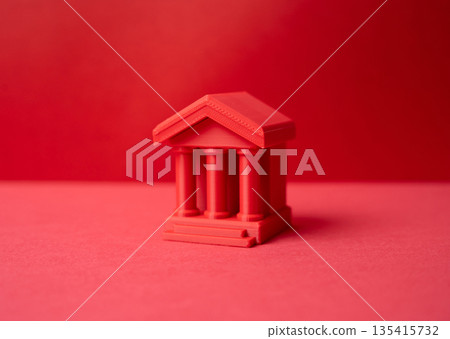 A red bank building on a red background. Finance and public administration. State control concept, financial authority, regulation power and centralized economic decision making 135415732