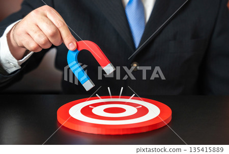 Attracting your target audience. Bringing you closer to your goal. A businessman with a magnet. Precision marketing concept, customer attraction and influence strategy. Focused outreach Attracting your target audience. Bringing you closer to your goal. A businessman with a magnet. Precision marketing concept, customer attraction and influence strategy. Focused outreach 135415889