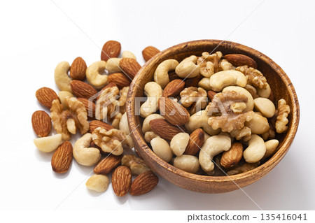 Mixed nuts in a wooden bowl Mixed nuts in a wooden bowl 135416041