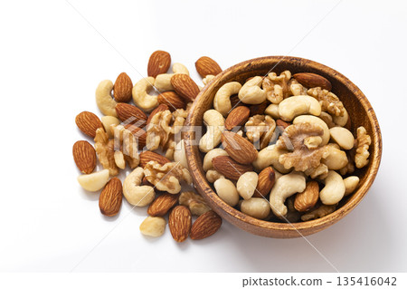 Mixed nuts in a wooden bowl Mixed nuts in a wooden bowl 135416042