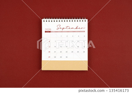 September 2026 desk calendar on red leather. 135416173