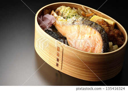 Chikuwa tempura, fried chicken, grilled salmon, and nori bento 135416324