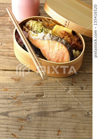 Chikuwa tempura, fried chicken, grilled salmon, nori bento and water bottle 135416520