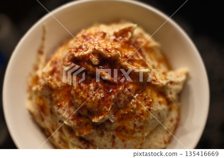 Traditional chickpea hummus with olive oil, spices, and fresh toppings. Traditional chickpea hummus with olive oil, spices, and fresh toppings. 135416669