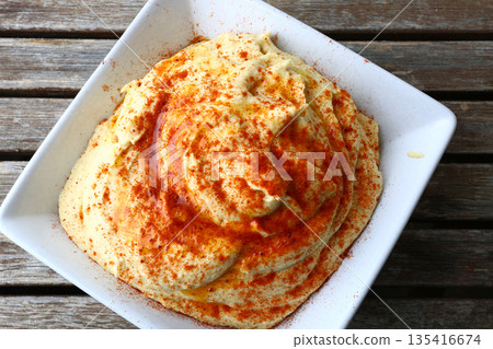 Traditional chickpea hummus with olive oil, spices, and fresh toppings. Traditional chickpea hummus with olive oil, spices, and fresh toppings. 135416674