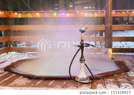Frosty exterior scene featuring steaming pipes and vibrant lighting Frosty exterior scene featuring steaming pipes and vibrant lighting 135416937