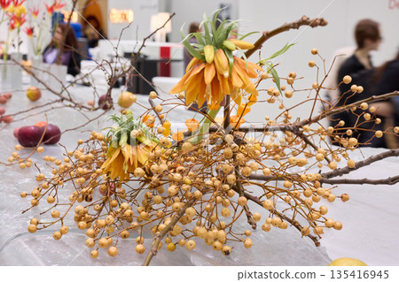 Chic floral centerpiece with vibrant berries arranged beautifully Chic floral centerpiece with vibrant berries arranged beautifully 135416945