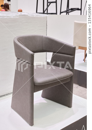 Stylish sculptural chair featuring modern design and soft fabric finish 135416964