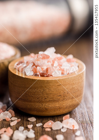 Pink Himalayan salt in bowl on wooden table. Pink Himalayan salt in bowl on wooden table. 135417955