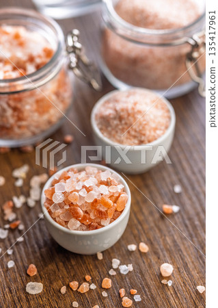 Pink Himalayan salt in bowl on wooden table. Pink Himalayan salt in bowl on wooden table. 135417961