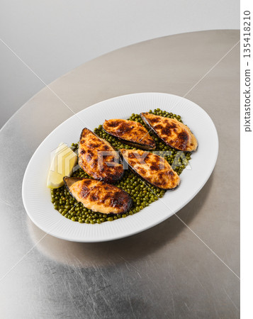 Delicious baked shellfish presented on rustic coastal dish 135418210