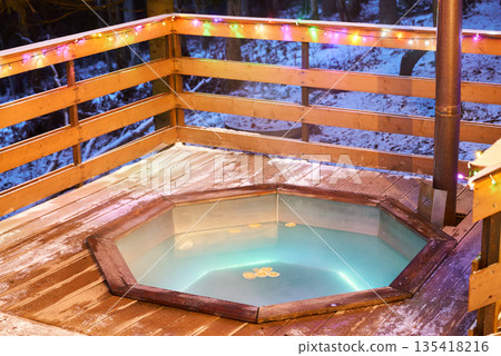 Illuminated spa with floating orange segments and atmospheric lights Illuminated spa with floating orange segments and atmospheric lights 135418216