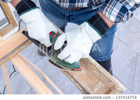 Carpenter at work, restoring an old wooden window. Carpentry. 135418758