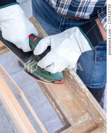 Carpenter at work, restoring an old wooden window. Carpentry. Carpenter at work, restoring an old wooden window. Carpentry. 135418759