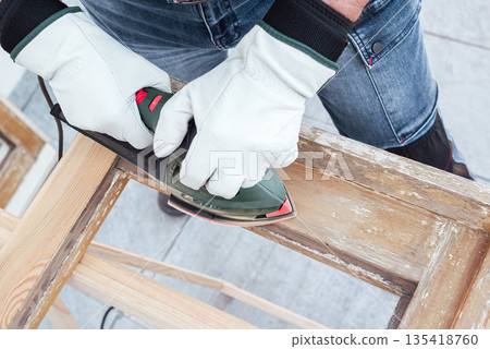 Carpenter at work, restoring an old wooden window. Carpentry. Carpenter at work, restoring an old wooden window. Carpentry. 135418760