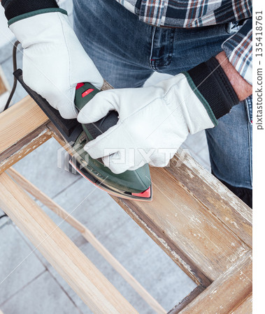 Carpenter at work, restoring an old wooden window. Carpentry. Carpenter at work, restoring an old wooden window. Carpentry. 135418761