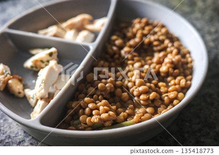 Close-up of cooked lentils and chicken for baby food 135418773
