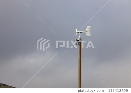 Blade type or Windmill type anemometer on top of the pole, install near crater of volcano. 135418799