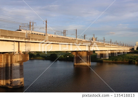 Tohoku Shinkansen E2 series train passing Todabashi Bridge at dusk (Toda City, Saitama Prefecture) Tohoku Shinkansen E2 series train passing Todabashi Bridge at dusk (Toda City, Saitama Prefecture) 135418813