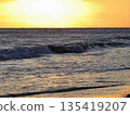 Waves crashing on the beach and sunset sky 135419207