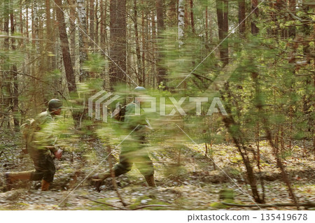American Soldiers Of USA Infantry Of World War II Marching Running Run Along Forest In Autumn Spring Day. Group of soldiers American Soldiers Of USA Infantry Of World War II Marching Running Run Along Forest In Autumn Spring Day. Group of soldiers 135419678