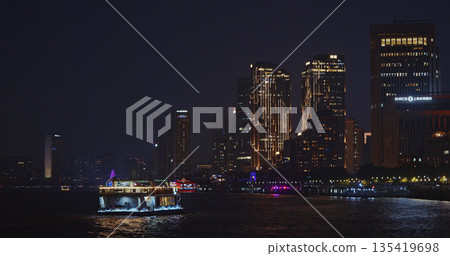 Scenic Night View of Riverboat Illuminated by Cityscape in Shang Scenic Night View of Riverboat Illuminated by Cityscape in Shang 135419698