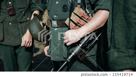 Re-enactor Dressed As German Wehrmacht Infantry Soldier In World War Ii With Submachine Gun Mp 40. German Soldier Uniform. German Soldier's Outfit 135419714