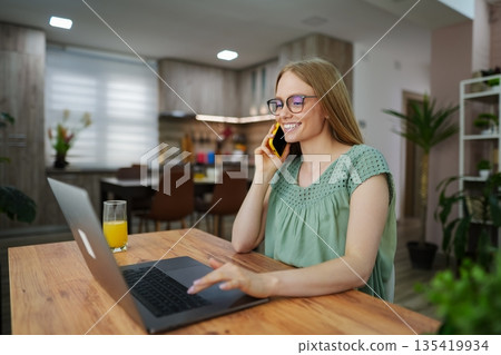 Enjoying a productive day at home office with a cheerful conversation 135419934