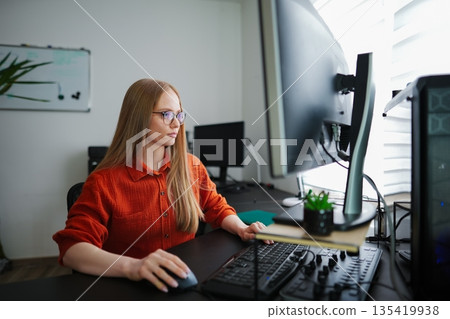 Engaging in focused work at a modern home office environment 135419938