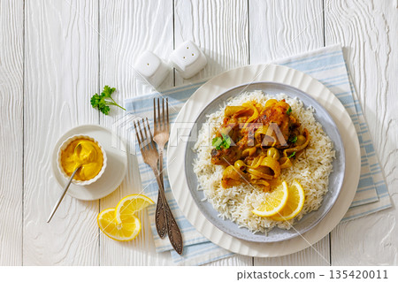 Braised Mustard Chicken Yassa with Rice on a plate 135420011