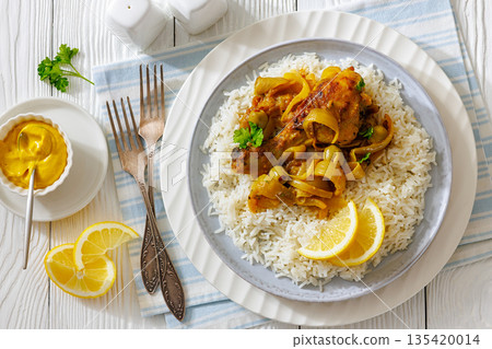Braised Mustard Chicken Yassa with Rice on a plate Braised Mustard Chicken Yassa with Rice on a plate 135420014