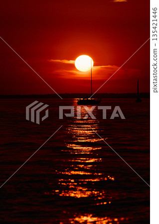 Sailing regatta in the Gulf of Finland at sunset, few sailing yachts competing in a race, splashing water from under the boats, teamwork, board the boat 135421446