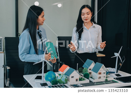 Hands of adult Asian business professionals analyzing ESG financial data and renewable energy project plans Hands of adult Asian business professionals analyzing ESG financial data and renewable energy project plans 135423310
