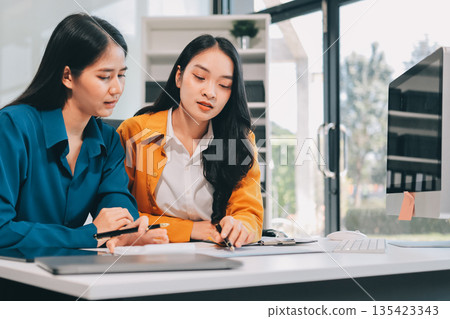 Businesswomen having discussion in office 135423343