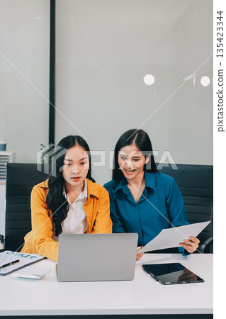 Businesswomen having discussion in office Businesswomen having discussion in office 135423344