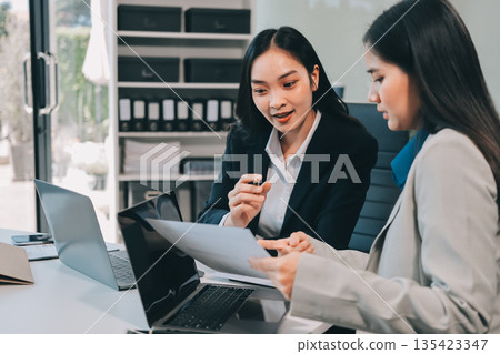 Businesswomen having discussion in office Businesswomen having discussion in office 135423347